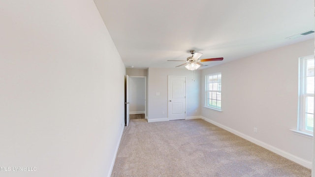 7876 Gardendale Dr, Olive Branch, MS 38654 - empty room with healthy amount of natural light, a ceiling fan, and light carpet