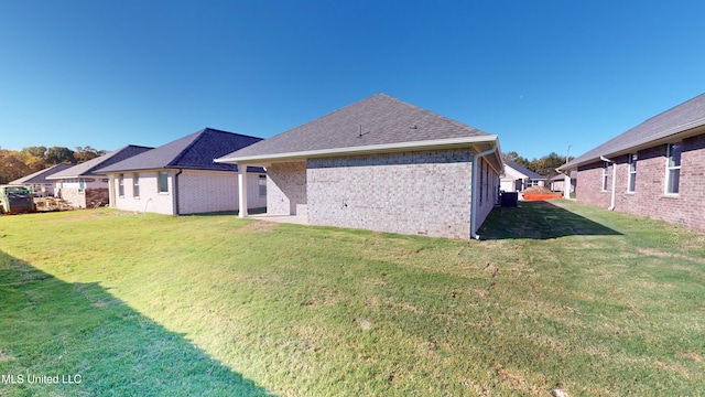 7876 Gardendale Dr, Olive Branch, MS 38654 - rear view of property with a yard, brick siding, and a shingled roof