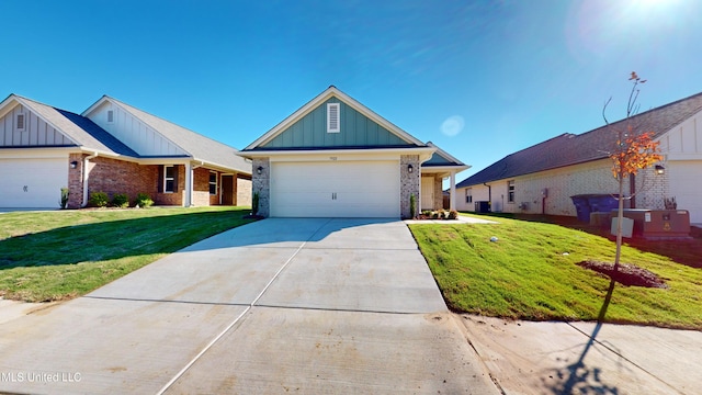 7876 Gardendale Dr, Olive Branch, MS 38654 - ranch-style home with board and batten siding, brick siding, a front yard, driveway, and an attached garage