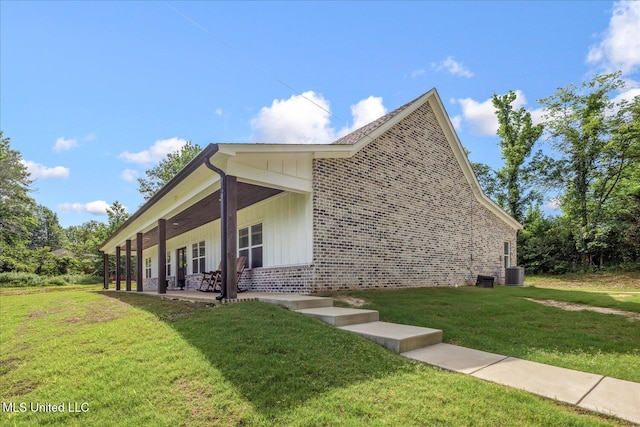 335 Aaron Rd, Sarah, MS 38665 - view of side of home featuring brick siding, a yard, and central AC