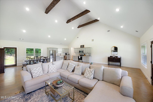 335 Aaron Rd, Sarah, MS 38665 - living area with high vaulted ceiling, beamed ceiling, recessed lighting, light wood-style flooring, and baseboards