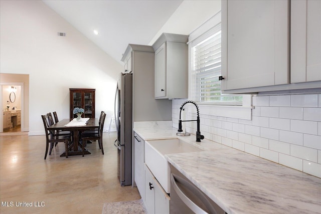 335 Aaron Rd, Sarah, MS 38665 - kitchen featuring a sink, appliances with stainless steel finishes, tasteful backsplash, gray cabinetry, and light stone countertops