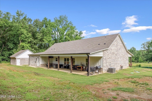335 Aaron Rd, Sarah, MS 38665 - rear view of house with a patio area, a lawn, an outdoor living space, central AC, and a shingled roof
