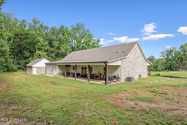 335 Aaron Rd, Sarah, MS 38665 - back of property with a patio area, central AC, a yard, and board and batten siding