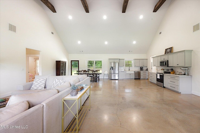 335 Aaron Rd, Sarah, MS 38665 - living room featuring high vaulted ceiling, beamed ceiling, concrete floors, recessed lighting, and baseboards