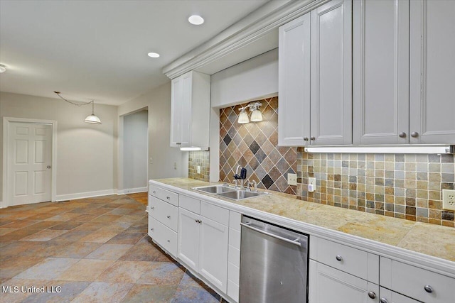 kitchen featuring dishwasher, tasteful backsplash, a sink, and white cabinetry