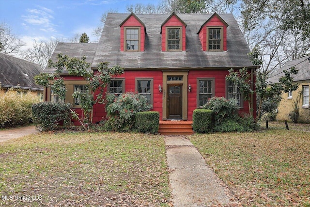 view of front of home with a tiled roof and a front yard