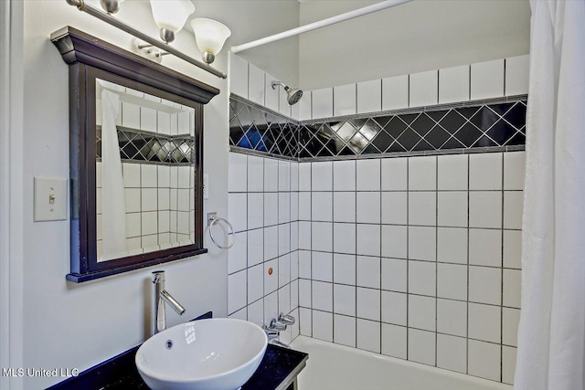 bathroom with shower / tub combo and a sink