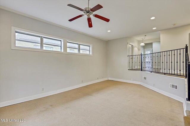 unfurnished room featuring light carpet, recessed lighting, visible vents, and baseboards