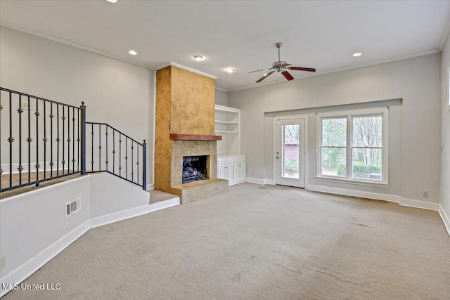 unfurnished living room with ornamental molding, a high end fireplace, visible vents, and baseboards