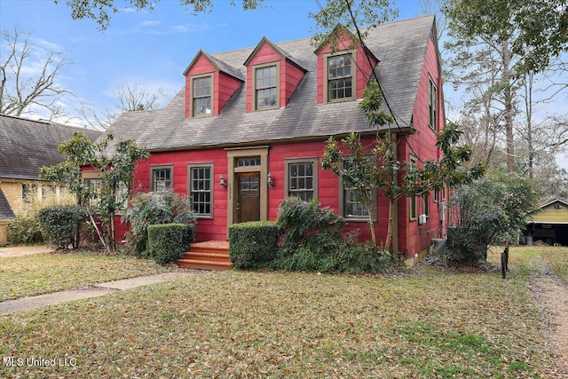 cape cod home with a front lawn