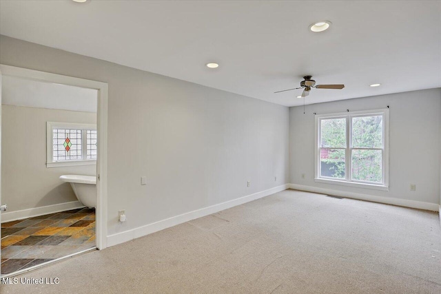 carpeted empty room featuring recessed lighting, plenty of natural light, and baseboards