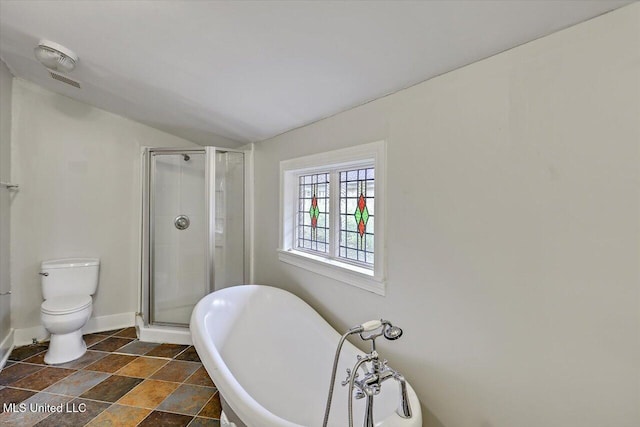 full bath with a freestanding bath, a shower stall, toilet, and baseboards