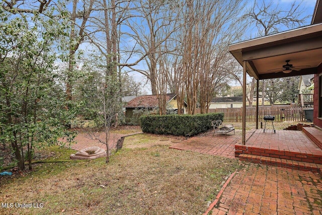 view of yard with a patio area, fence, and a ceiling fan