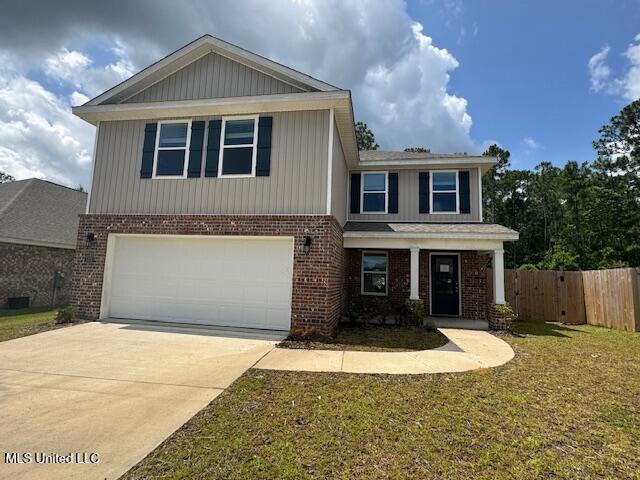 5378 Leeds Ln, Biloxi, MS 39532 - view of front of property featuring brick siding, an attached garage, and driveway