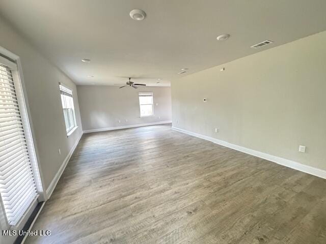 5378 Leeds Ln, Biloxi, MS 39532 - empty room with plenty of natural light, baseboards, wood finished floors, and a ceiling fan