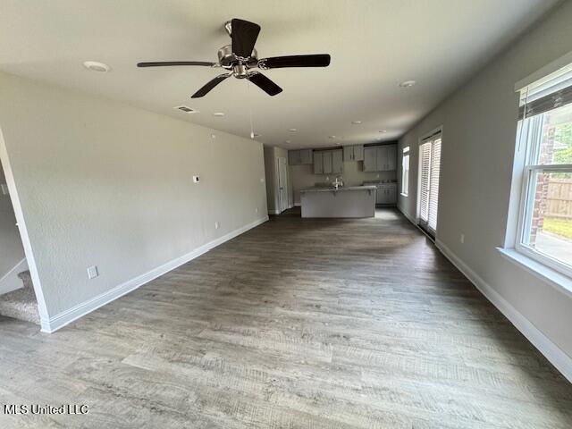 5378 Leeds Ln, Biloxi, MS 39532 - unfurnished living room with wood finished floors, baseboards, and a ceiling fan