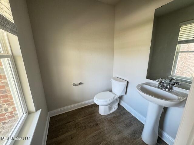 5378 Leeds Ln, Biloxi, MS 39532 - half bath with toilet, wood finished floors, and baseboards