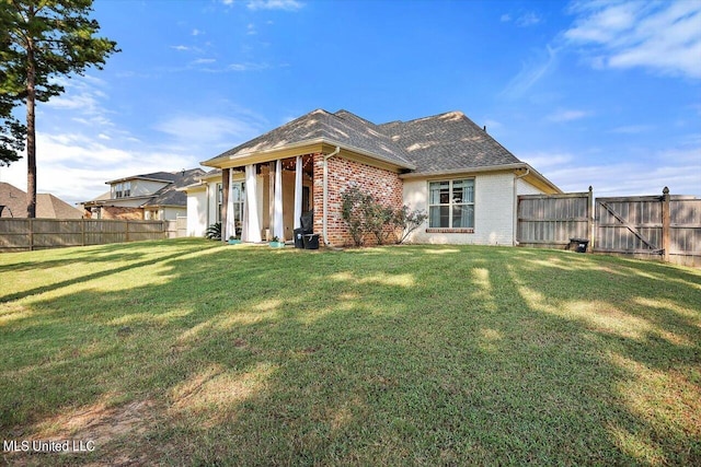 105 Twain Trl, Clinton, MS 39056 - rear view of property with a fenced backyard, a shingled roof, a yard, and brick siding