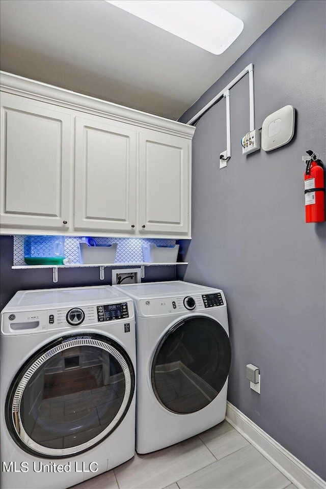 washroom with cabinets and separate washer and dryer