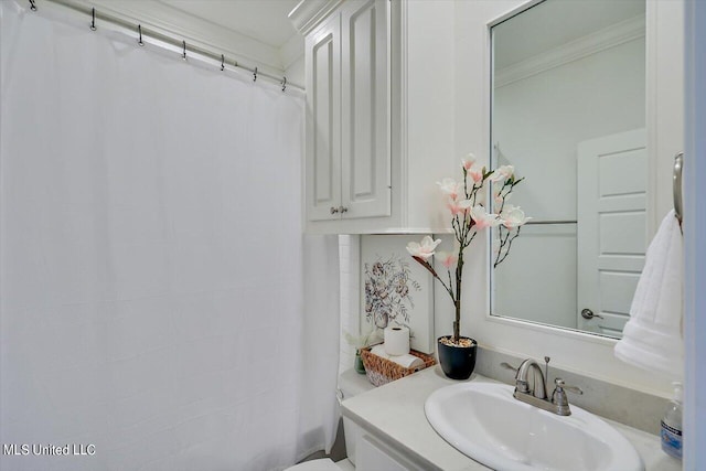 bathroom featuring vanity, ornamental molding, and a shower with curtain