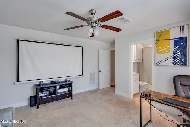 carpeted cinema room featuring ceiling fan