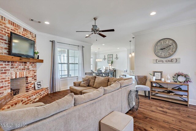 105 Twain Trl, Clinton, MS 39056 - living area with dark wood-style flooring, crown molding, a brick fireplace, and ceiling fan