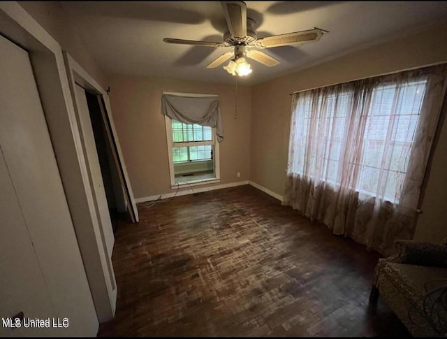 20454 Saucier Advance Rd, Saucier, MS 39574 - unfurnished bedroom with baseboards, a ceiling fan, and dark wood finished floors