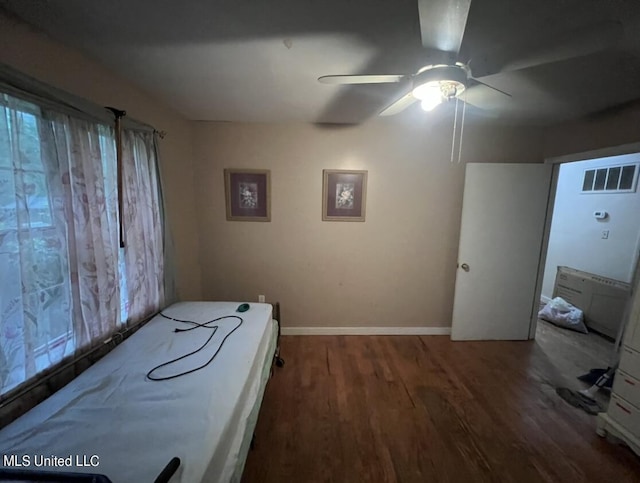 20454 Saucier Advance Rd, Saucier, MS 39574 - bedroom featuring baseboards, wood finished floors, visible vents, and multiple windows