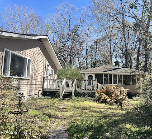 20454 Saucier Advance Rd, Saucier, MS 39574 - view of side of home featuring a deck and a sunroom