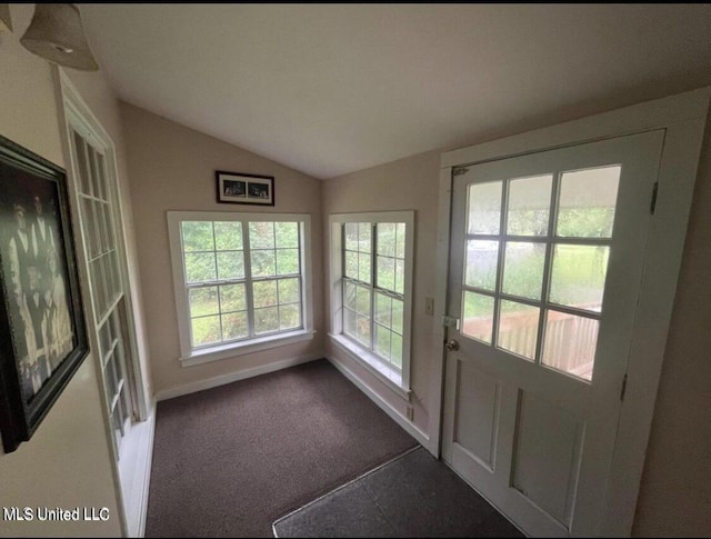 20454 Saucier Advance Rd, Saucier, MS 39574 - doorway with baseboards, vaulted ceiling, and dark colored carpet