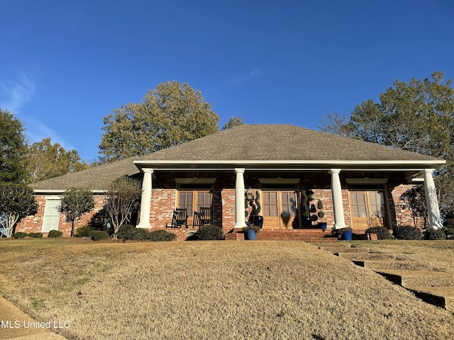 view of front of house with a porch and a front lawn