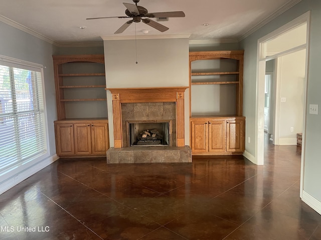 unfurnished living room with a tile fireplace, crown molding, dark tile patterned floors, and ceiling fan