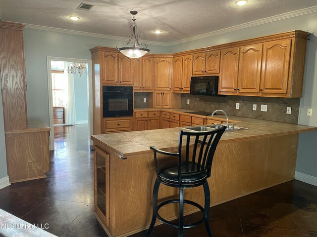 kitchen featuring kitchen peninsula, decorative backsplash, sink, black appliances, and hanging light fixtures