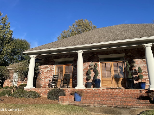 rear view of house featuring a porch