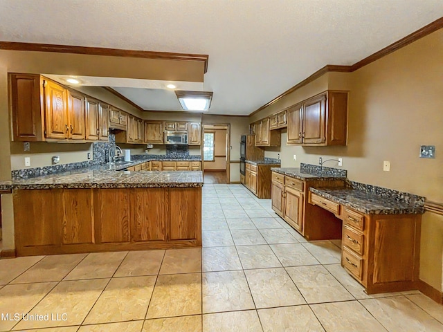 kitchen with ornamental molding, sink, kitchen peninsula, and light tile patterned floors