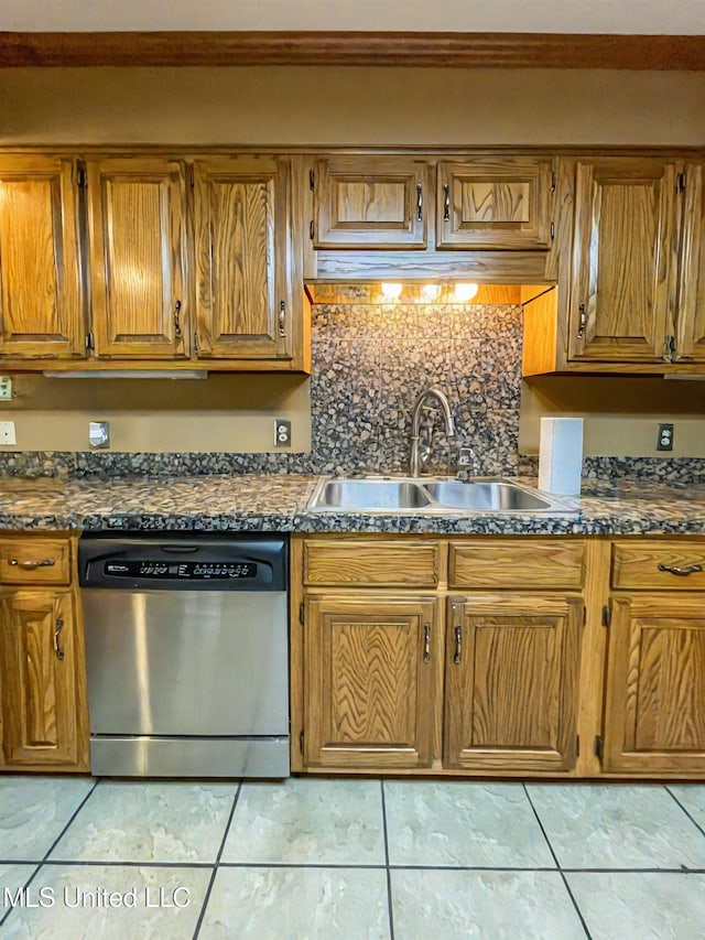 kitchen featuring light tile patterned floors, tasteful backsplash, sink, and stainless steel dishwasher