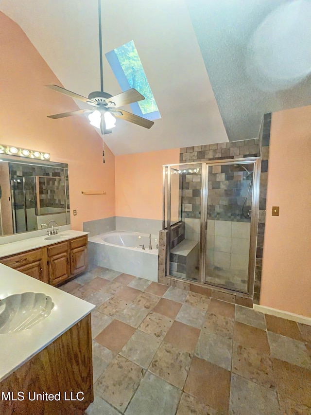 bathroom with vanity, independent shower and bath, lofted ceiling with skylight, and ceiling fan