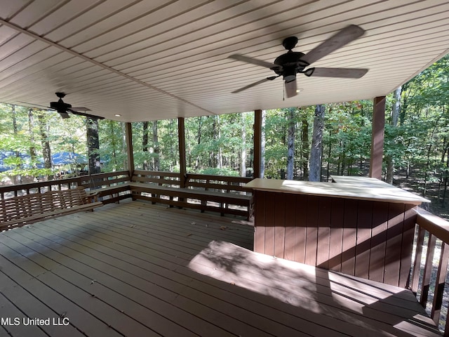 deck featuring a jacuzzi and ceiling fan