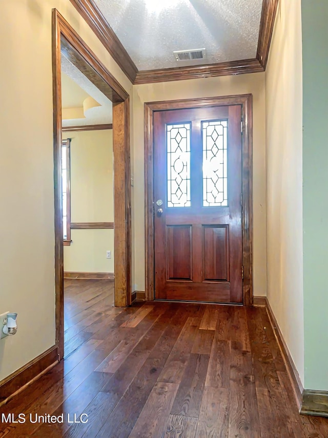 foyer entrance with crown molding, a textured ceiling, and dark hardwood / wood-style flooring