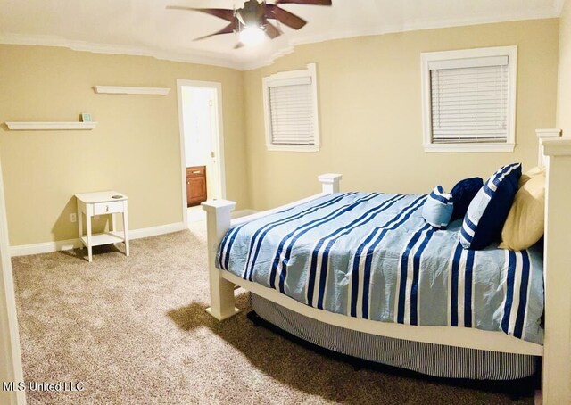 carpeted bedroom featuring crown molding, ensuite bathroom, baseboards, and ceiling fan