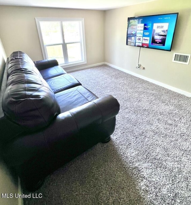 carpeted living room featuring baseboards and visible vents