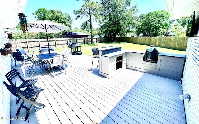 deck featuring a fenced backyard and outdoor dining space