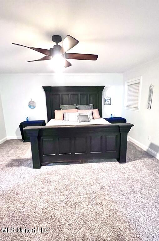 carpeted bedroom with baseboards and a ceiling fan