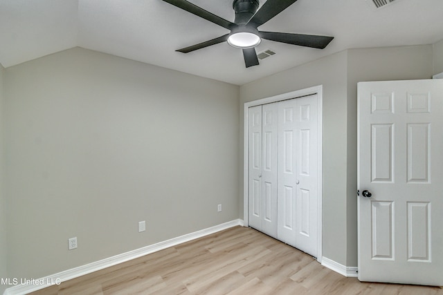 unfurnished bedroom with lofted ceiling, light hardwood / wood-style flooring, a closet, and ceiling fan