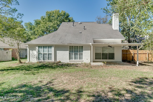 back of house featuring a lawn