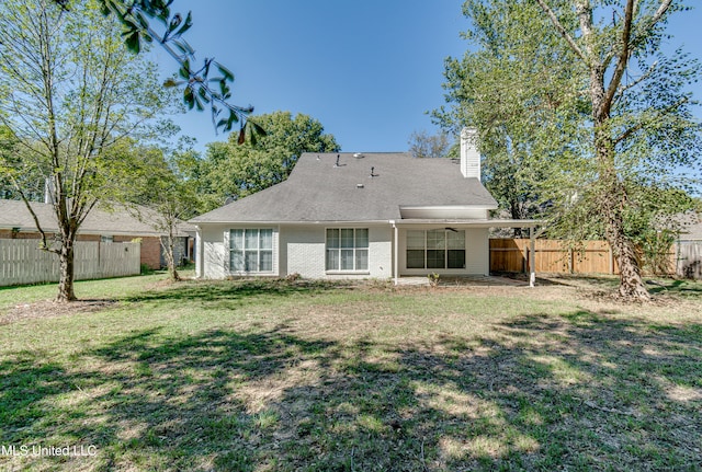 back of house with a lawn