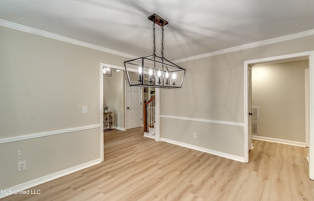 unfurnished dining area featuring light hardwood / wood-style floors, a notable chandelier, and ornamental molding