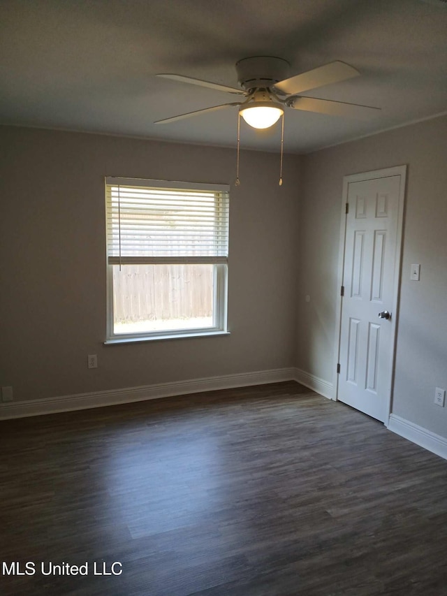 empty room with dark wood-type flooring and ceiling fan