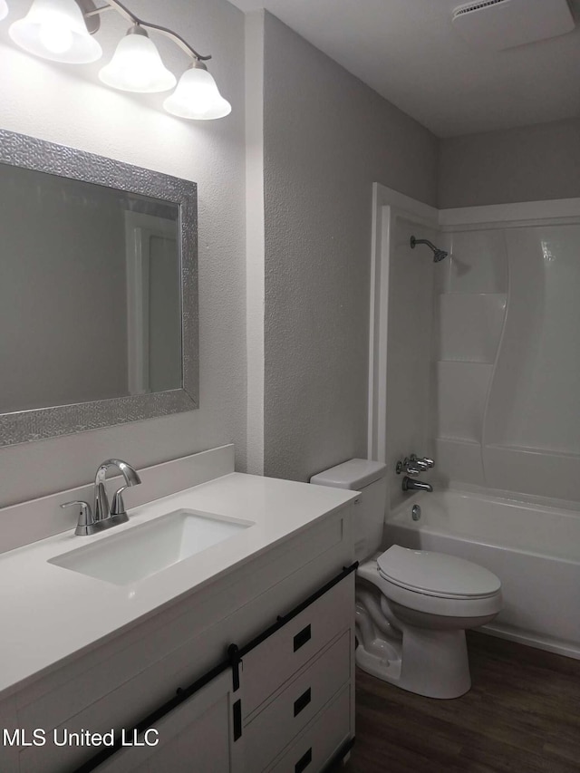 full bathroom with vanity, wood-type flooring,  shower combination, and toilet